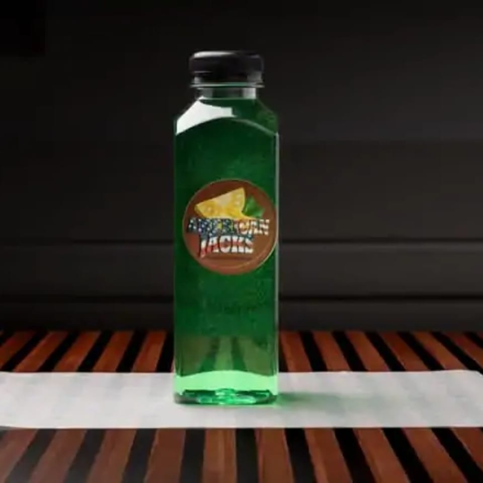 A green bottled drink with a circular "American Jacks" label featuring cheese and herbs.
