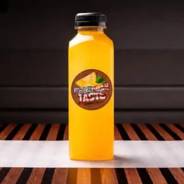 A yellow bottle of "Perfect Taste" juice with a brown label featuring a cheese slice and mint leaf.